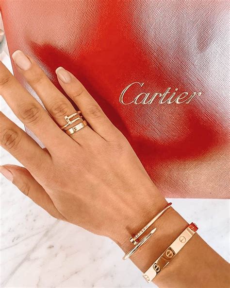 cartier love ring on hand.